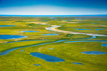 Landscape of the arctic tundra in summer. Rivers, lakes, northern vegetation. View from above. The...