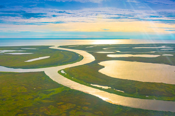 Evening sunset on the coast of the Arctic Ocean. Summer arctic landscape. The concept of climate change, warming in the Arctic.