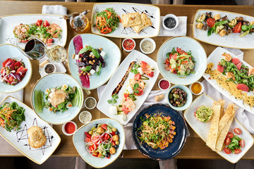 Variety of dishes on the table. Various snacks and antipasti on the table. Restaurant menu. Italian cuisine