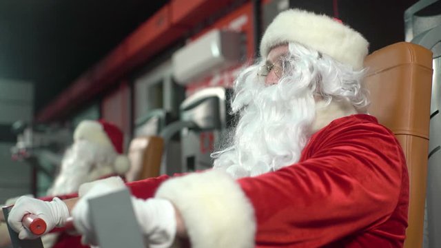 Santa Claus training at the gym on Christmas Day