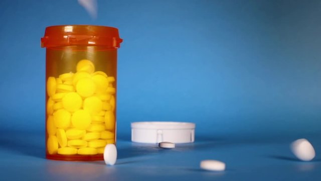 Opioid Crisis - Open Bottle of Prescription Painkillers. Chemist, doctor.