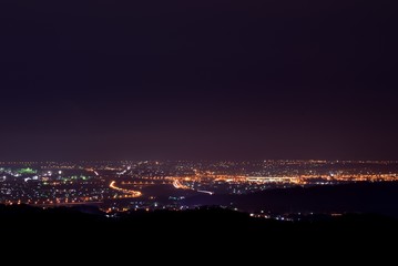 Naklejka premium Aerial night view of a countryside. Beautiful landscape panorama at night. Aerial view city on the mountain.