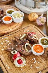 Lamb tongue kebab with Pickled cabbage and two sauces. Barbecue restaurant menu. Many different food on the table. Dinner party or Banquet