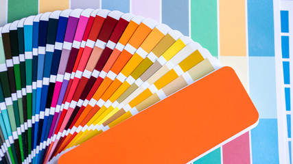 Color swatches of graphic designers putting on desk table.