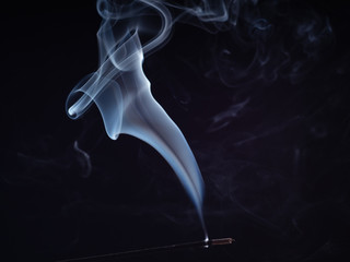 White smoke steam isolated on black background, close up view. Structure of white smoke, brush effect. Abstract background of burning incense. Fragrance for relaxation and meditation
