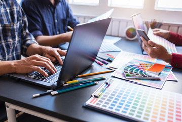 Group of artists brainstorming planning partnership strategy to coworkers in creative office.