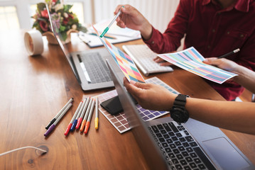 Asian colleagues designer drawing sketches on graphic laptop.