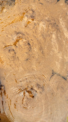 A water source flows out from under the ground like as blurred abstract background