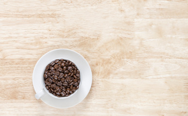 coffee beans in white coffee mugs on the wooden background ..