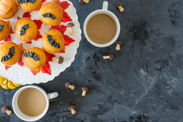 Halloween pumpkin cupcakes with 2 cups of coffee