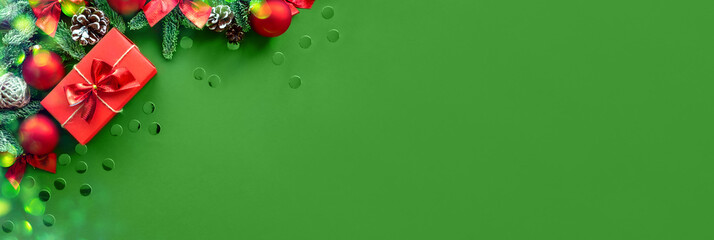 Christmas composition. Background green color with gift box and decorations. Copy space. Holiday...