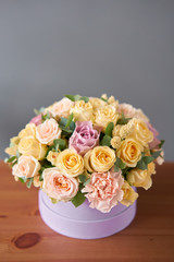 Floral shop concept . Flower arrangement in a round box. Beautiful bouquet of mixed flowers. Handsome fresh bunch. Flowers delivery