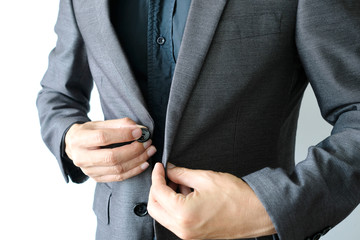 Business man is wearing a black suit and button up in the morning of the working day white background.
