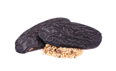Tonka beans isolated on white background. Bean of Dipteryx odorata, cumaru or kumaru. Fresh aroma tonka bean powder. Close-up.