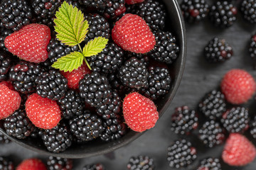 Background from fresh organic blackberries and raspberries, close up. Top view blackberry and raspberry