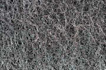 Fototapeta na wymiar Dark abstract background and pattern of interwoven hairs, fibers and nanofibers. Sponge detail texture, sponge texture closeup background. Cellulose sponge texture. Black and white