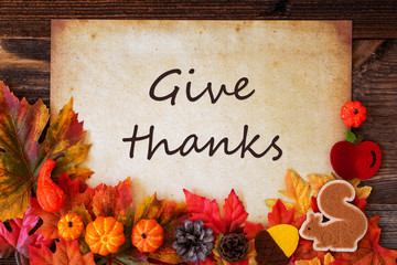 Old Paper With English Text Give Thanks. Colorful Autumn Decoration Like Leaves and Pumpkin