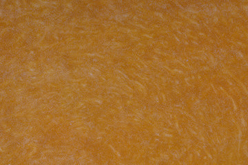Yellow pumpkin cut in half with the texture of pulp. Pumpkin slices background closeup, top view