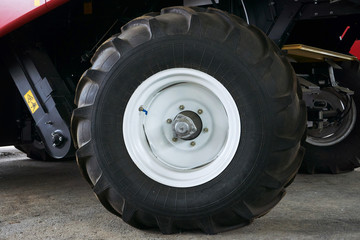 Obraz na płótnie Canvas large tires with a large tread on a new agricultural tractor after assembly at the plant on a sunny day