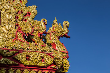 The end of the roof is decorated with a golden serpent.