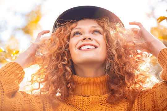Young adult woman looking up and smiling wide