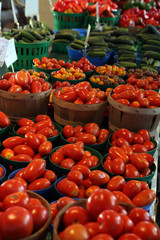 Biologic, natural cultivated tomatoes on a market counter.