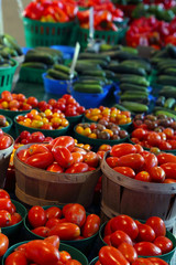Biologic, natural cultivated tomatoes on a market counter.