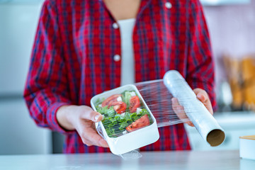 Using food polyethylene plastic film for food storage in fridge at home