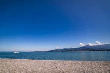 Scenery of black sea on a background of mountains in Batumi, Georgia on a sunny clear day
