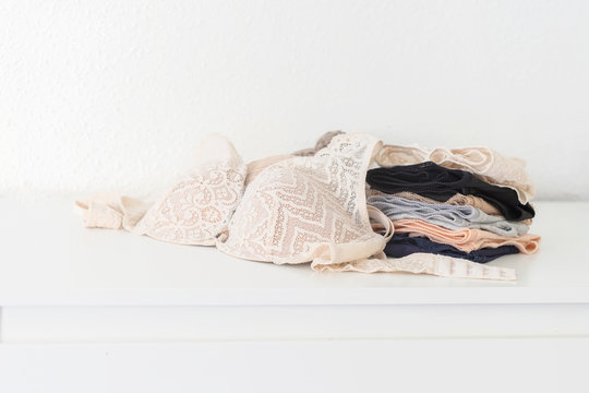 Sexy women's panties and bras on white table. Female underwear background for  fashion blogging. Copy space