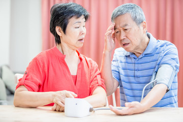 elder couple use blood manometer