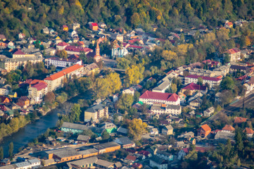 Fototapeta na wymiar A small town among the mountains in autumn, top view