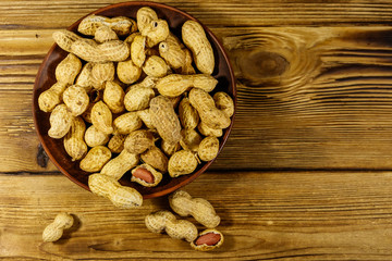 Peanuts in nutshell on a wooden table. Top view