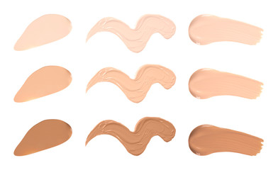 Set of different foundation shades on white background, top view