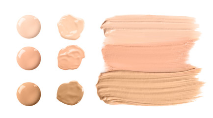 Set of different foundation shades on white background, top view
