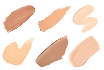 Set of different foundation shades on white background, top view