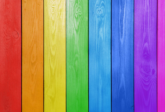 Texture of rainbow wooden surface as background, top view