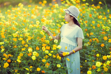 Pregnant woman are happy In the flower garden
