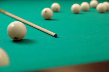 Balls and cue on modern billiard table