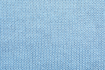 Light blue winter sweater as background, closeup view