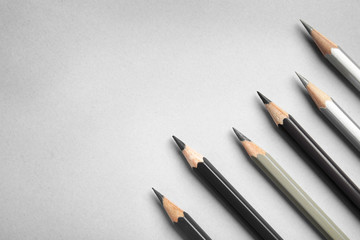 Flat lay composition with color pencils on grey background, space for text