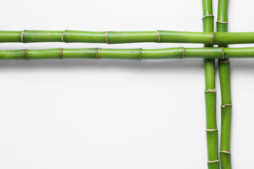 Fototapeta premium Green bamboo stems on white background, top view