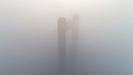 Pylon of the North Bridge or Moscow Bridge in dense dense fog in Kiev, Ukraine