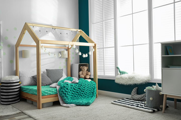 Cozy child room interior with comfortable bed