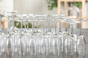 Empty glasses on wooden table against blurred background