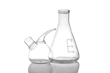 Empty retort and conical flasks on white background. Laboratory glassware