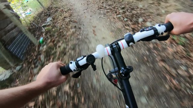 POV, Original point of view. Going down on bicycle. Moutain bikie in the forest.