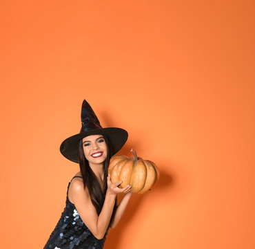 Beautiful Woman Wearing Witch Costume With Pumpkin For Halloween Party On Yellow Background, Space For Text