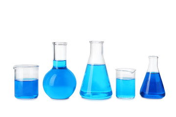 Laboratory glassware with blue liquids isolated on white