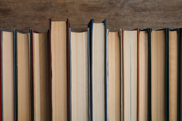 Stack of hardcover books on wooden background